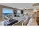 Spacious living room featuring calming paint colors, water views, and comfortable seating with accent pillows and ottoman at 1 Colony Point Dr # 11A, Punta Gorda, FL 33950