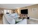 Inviting living room featuring a comfortable sectional, entertainment center, and bright lighting at 1 Colony Point Dr # 11A, Punta Gorda, FL 33950