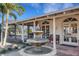 Beautiful outdoor patio featuring a water fountain, decorative doors and poolside access at 1 Colony Point Dr # 11A, Punta Gorda, FL 33950