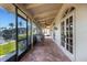 Relaxing covered patio with brick flooring, ceiling fans, and views of the canal at 1 Colony Point Dr # 11A, Punta Gorda, FL 33950