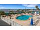 Inviting community pool area featuring lounge chairs, a charming waterfront view, and a tranquil atmosphere at 1 Colony Point Dr # 11A, Punta Gorda, FL 33950