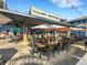 Outdoor restaurant featuring wooden tables, chairs, and umbrellas, perfect for enjoying a meal in a scenic setting at 1 Colony Point Dr # 11A, Punta Gorda, FL 33950