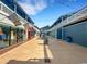 Inviting outdoor shopping center with colorful shops and string lights, creating a charming atmosphere at 1 Colony Point Dr # 11A, Punta Gorda, FL 33950