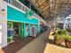 Charming shops with colorful facades line the brick-paved walkway, inviting visitors to explore the unique offerings at 1 Colony Point Dr # 11A, Punta Gorda, FL 33950