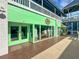 Attractive storefront with green trim and large windows displaying merchandise and mannequins at 1 Colony Point Dr # 11A, Punta Gorda, FL 33950