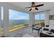 Bright sunroom with tiled floors and floor-to-ceiling windows overlooking scenic water views at 1 Colony Point Dr # 11A, Punta Gorda, FL 33950