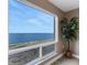 Gorgeous water view through a large picture window, complemented by a potted tree and tile flooring at 1 Colony Point Dr # 11A, Punta Gorda, FL 33950