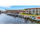 Beautiful waterfront condo with boat slips, manicured green spaces, and a picturesque building with a red tile roof at 1 Colony Point Dr # 11A, Punta Gorda, FL 33950