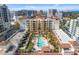 A captivating aerial view of the building featuring a pool, palm trees, and well-maintained landscaping at 100 Central Ave # C619, Sarasota, FL 34236