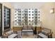 Inviting balcony with woven seating and decorative pillows, offering an outdoor space with a view of the building across at 100 Central Ave # C619, Sarasota, FL 34236