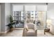 Living room view of a balcony with outdoor seating and a view of neighboring buildings at 100 Central Ave # C619, Sarasota, FL 34236