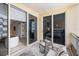 Condo balcony with sliding glass doors leading to living spaces, complete with neutral outdoor seating and city views at 100 Central Ave # C619, Sarasota, FL 34236