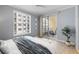 Serene bedroom with a cozy bed, modern decor, and a sunny balcony offering picturesque views at 100 Central Ave # C619, Sarasota, FL 34236