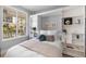 Contemporary bedroom featuring a built-in Murphy bed, white shelving, and a window with natural light at 100 Central Ave # C619, Sarasota, FL 34236
