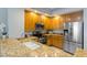 Modern kitchen featuring granite countertops, stainless steel appliances, and wood cabinets at 100 Central Ave # C619, Sarasota, FL 34236