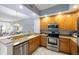Open kitchen with granite counters, stainless appliances and views of the adjacent living room at 100 Central Ave # C619, Sarasota, FL 34236