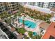 This outdoor pool has palm trees and lounge chairs and is surrounded by buildings at 100 Central Ave # C619, Sarasota, FL 34236