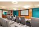 Home theater room featuring comfortable seating, a projector screen, and elegant wood accents at 100 Central Ave # C619, Sarasota, FL 34236