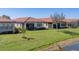 Well-kept lawn and landscaping define the rear of these homes with screened lanais at 10412 Crooked Creek Dr, Venice, FL 34293