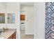 Bathroom leading to a laundry room equipped with a washer and dryer at 10412 Crooked Creek Dr, Venice, FL 34293