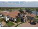 Stunning clubhouse aerial view featuring tropical landscaping, with nearby lake and golf course views at 10412 Crooked Creek Dr, Venice, FL 34293