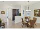 Inviting dining area with elegant lighting and seating for four at 10412 Crooked Creek Dr, Venice, FL 34293