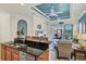 Open concept kitchen with island, granite countertop, stainless steel appliances, and lake views at 10412 Crooked Creek Dr, Venice, FL 34293