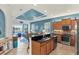 Kitchen view showcasing granite countertops, stainless steel appliances, and open floor plan with lake views at 10412 Crooked Creek Dr, Venice, FL 34293