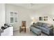 Cozy living room with rocking chair and ample natural light at 10412 Crooked Creek Dr, Venice, FL 34293