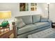 Comfortable living room space with a plush couch and stylish accents at 10412 Crooked Creek Dr, Venice, FL 34293