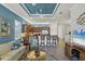 Open-concept living room featuring stylish furniture, a ceiling fan and access to the kitchen at 10412 Crooked Creek Dr, Venice, FL 34293