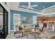 Bright living room with stylish furniture, and a view of the kitchen at 10412 Crooked Creek Dr, Venice, FL 34293