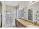 Spacious main bathroom featuring a dual sink vanity, step-in shower, and neutral color palette at 10412 Crooked Creek Dr, Venice, FL 34293