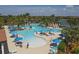 Relaxing community pool featuring clear blue water, lounge chairs, and mature palm trees at 10412 Crooked Creek Dr, Venice, FL 34293
