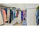 This is a view of the home's walk-in closet with shelving, rods, and plenty of storage space at 10412 Crooked Creek Dr, Venice, FL 34293