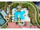 Aerial view of a large community pool and recreational facilities with palm trees and lounge chairs at 10742 Ironbridge Dr, Venice, FL 34293