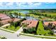 Beautiful aerial view of a home nestled in a community with a golf course and lake at 10742 Ironbridge Dr, Venice, FL 34293