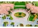 Aerial view of community clubhouse featuring manicured landscaping and circular driveway at 10742 Ironbridge Dr, Venice, FL 34293