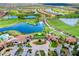 Aerial view of a clubhouse near a lush green golf course and multiple serene lakes at 10742 Ironbridge Dr, Venice, FL 34293