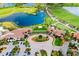 Aerial view of a community clubhouse near a lake and golf course at 10742 Ironbridge Dr, Venice, FL 34293