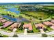 Aerial view of homes near a golf course, several lakes, lush landscaping, and community ammenities at 10742 Ironbridge Dr, Venice, FL 34293
