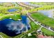 An aerial view of the golf course, with picturesque water features and lush greenery near the luxurious homes at 10742 Ironbridge Dr, Venice, FL 34293