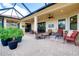 Expansive covered brick patio with ceiling fans, outdoor seating areas, and a spacious open design for entertaining at 10742 Ironbridge Dr, Venice, FL 34293