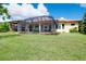 Spacious backyard with a well-maintained lawn and a screened-in patio for comfortable outdoor living at 10742 Ironbridge Dr, Venice, FL 34293