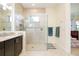 Modern bathroom showcasing a glass-enclosed shower and neutral tile at 10742 Ironbridge Dr, Venice, FL 34293