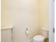 Neutral toned powder room shows toilet and custom cabinet at 10742 Ironbridge Dr, Venice, FL 34293