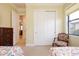 Comfortable bedroom boasts large window and view to other rooms at 10742 Ironbridge Dr, Venice, FL 34293