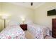 Bright bedroom featuring twin beds and a large window at 10742 Ironbridge Dr, Venice, FL 34293