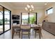 Bright dining area features a table for four and sliding glass doors with scenic outdoor views at 10742 Ironbridge Dr, Venice, FL 34293