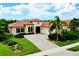 Charming single-Gathering home featuring tile roof, well-manicured lawn, and a spacious paver driveway at 10742 Ironbridge Dr, Venice, FL 34293